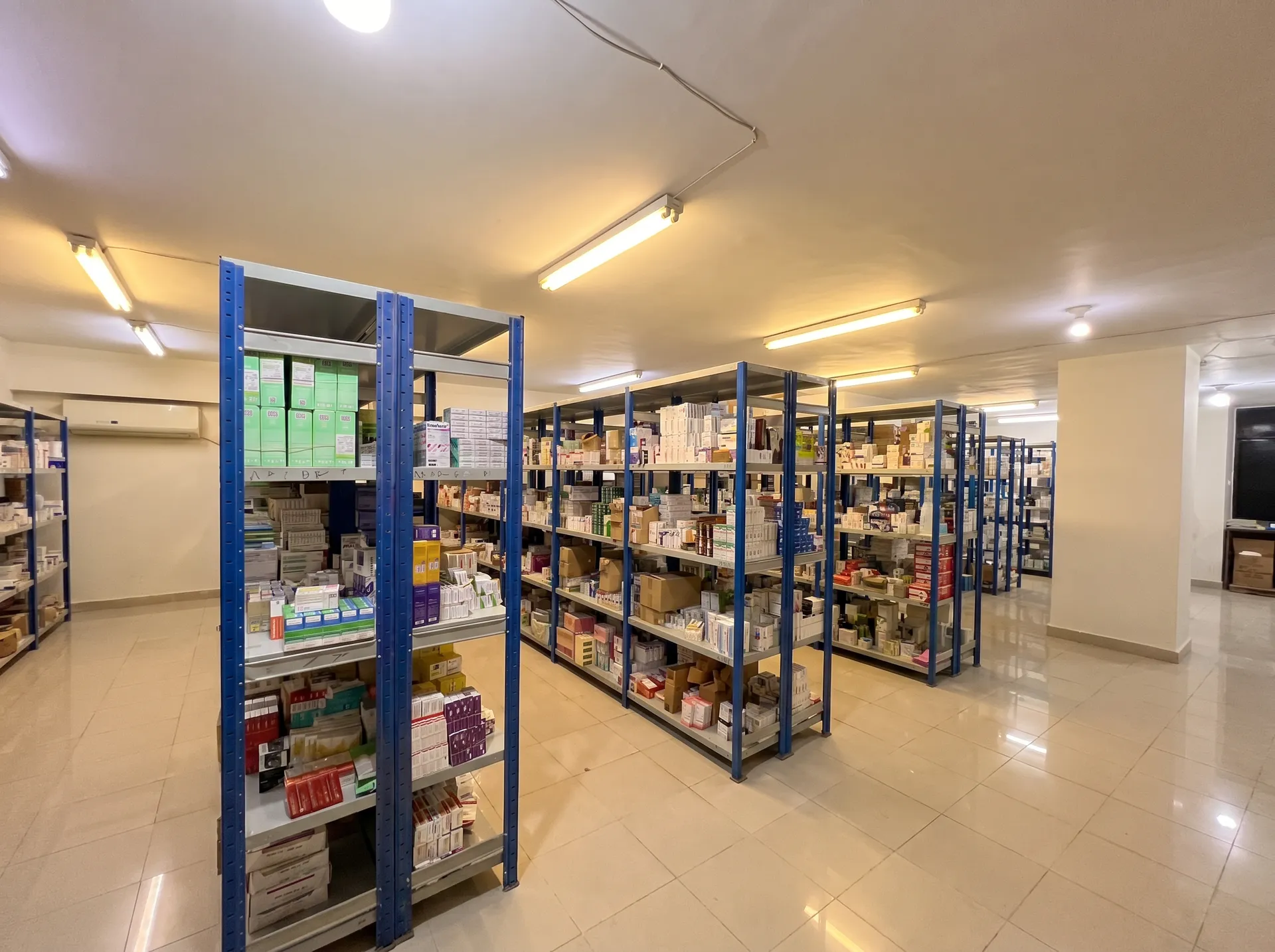 Epidis Pharma GSDP-compliant pharmaceutical warehouse with multiple aisles of organized inventory shelving
